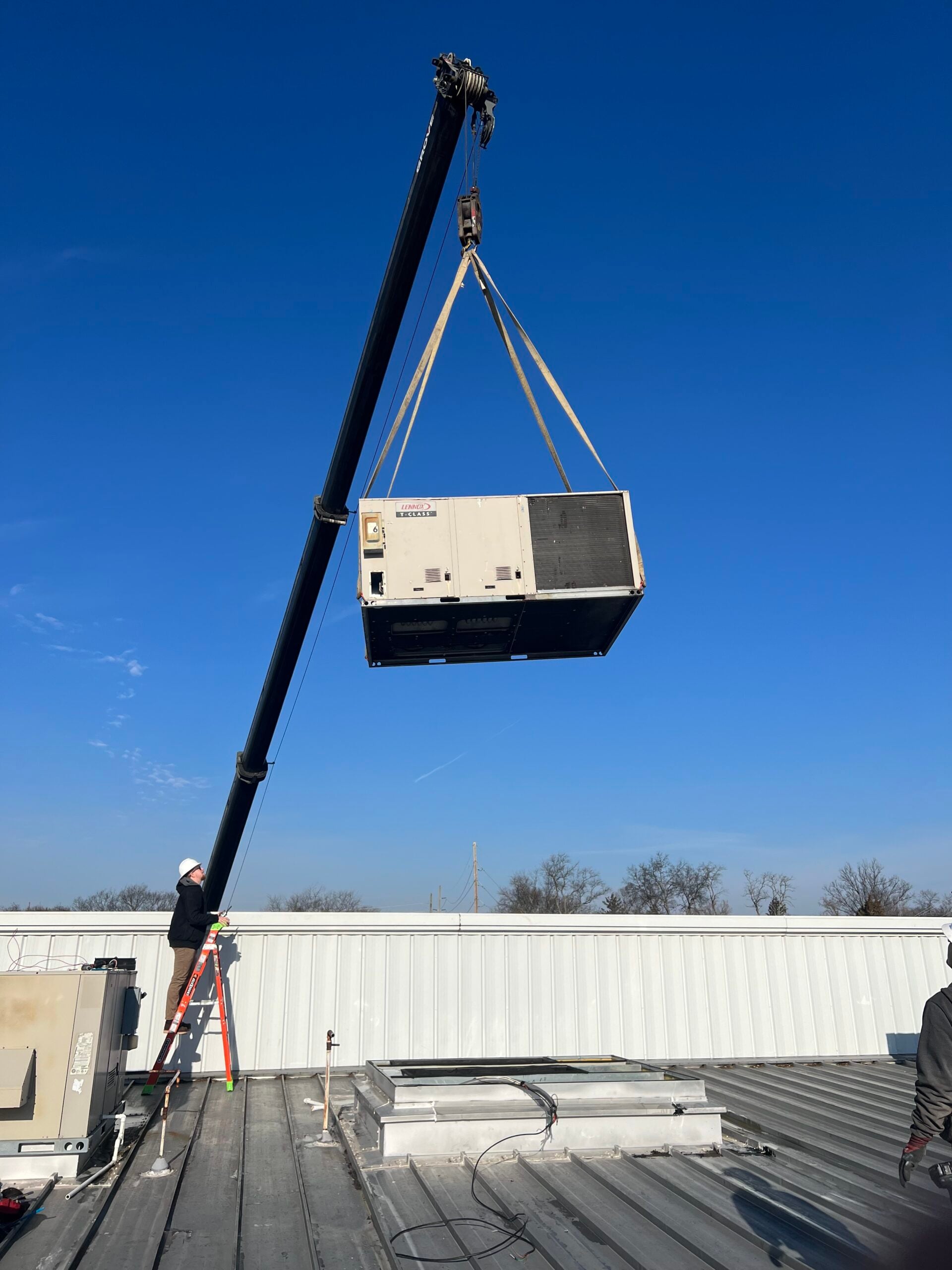 crane removing old lennox rtu commercial hvac unit from a church building