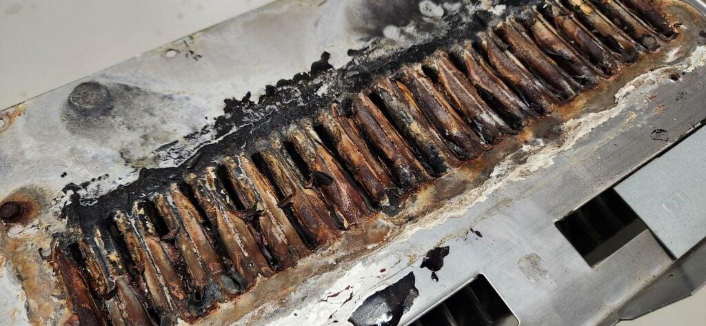 Clogged rusted secondary heat exchanger from a Bryant 355CAV high efficiency furnace manufactured in 2010